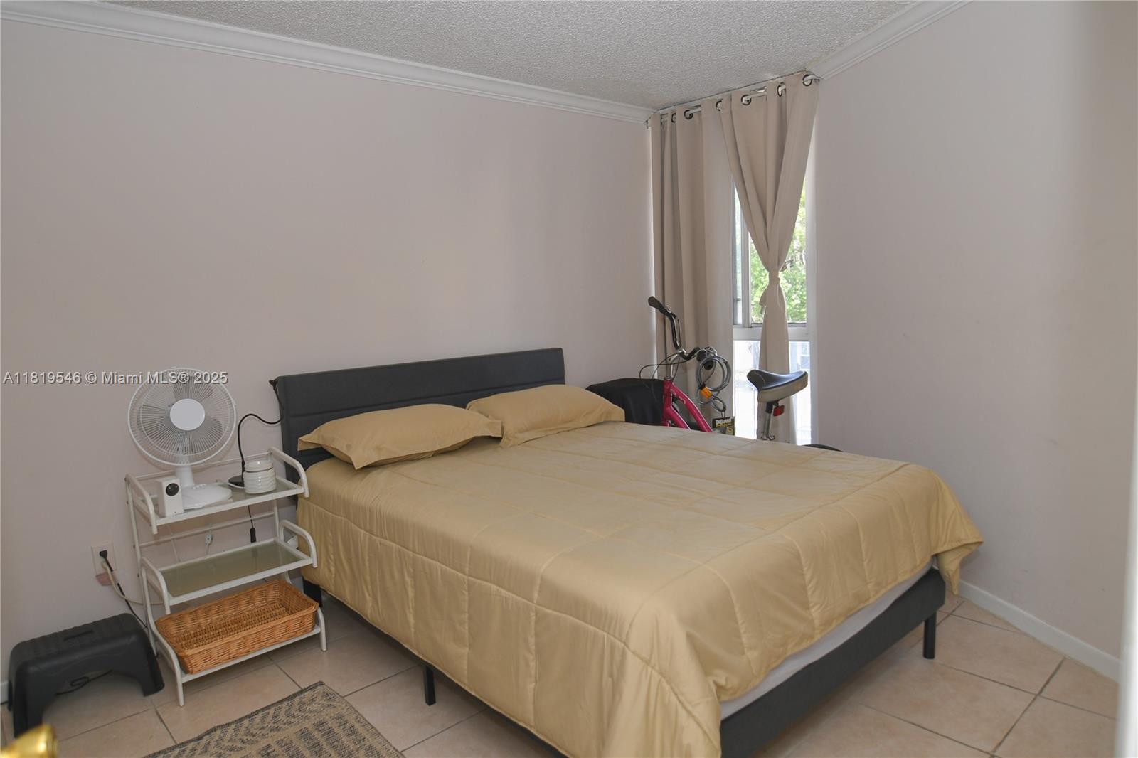7125 Northwest 186th Street, Unit B311 Hialeah, FL 33015 - Photo 5 of 31 a bedroom with a bed and a window
