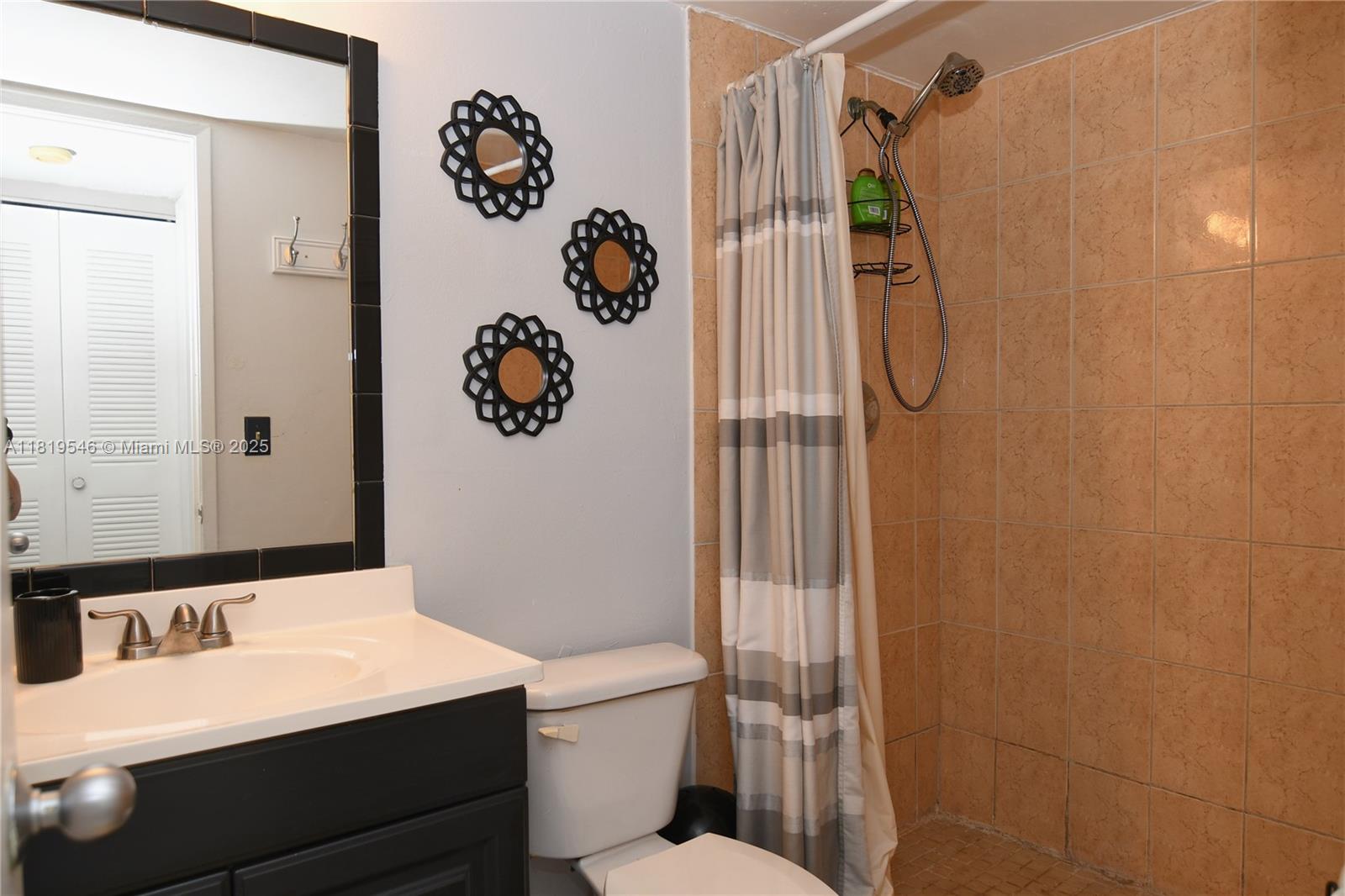 7125 Northwest 186th Street, Unit B311 Hialeah, FL 33015 - Photo 9 of 31 a bathroom with a sink toilet and shower
