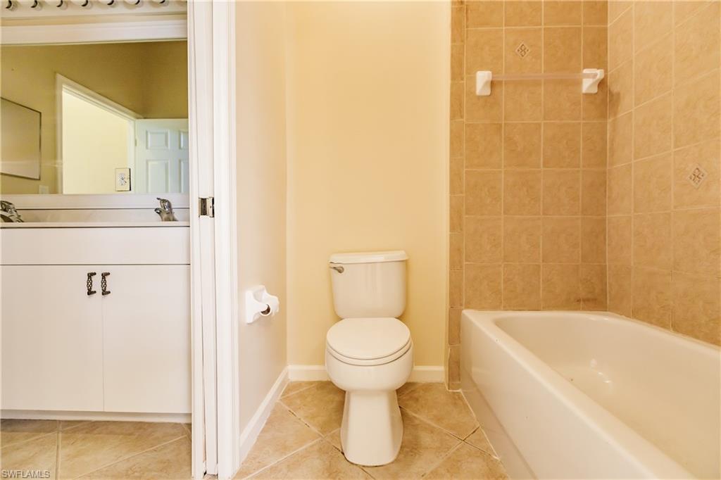 7868 Founders Circle Naples, FL 34104 - Photo 15 of 28 a bathroom with a bathtub and a toilet