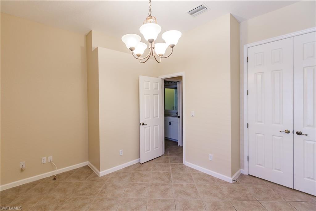 7868 Founders Circle Naples, FL 34104 - Photo 16 of 28 an empty room with wooden floor