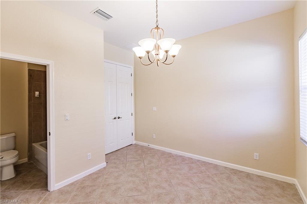 7868 Founders Circle Naples, FL 34104 - Photo 17 of 28 a view of a chandelier in big room and a bathroom