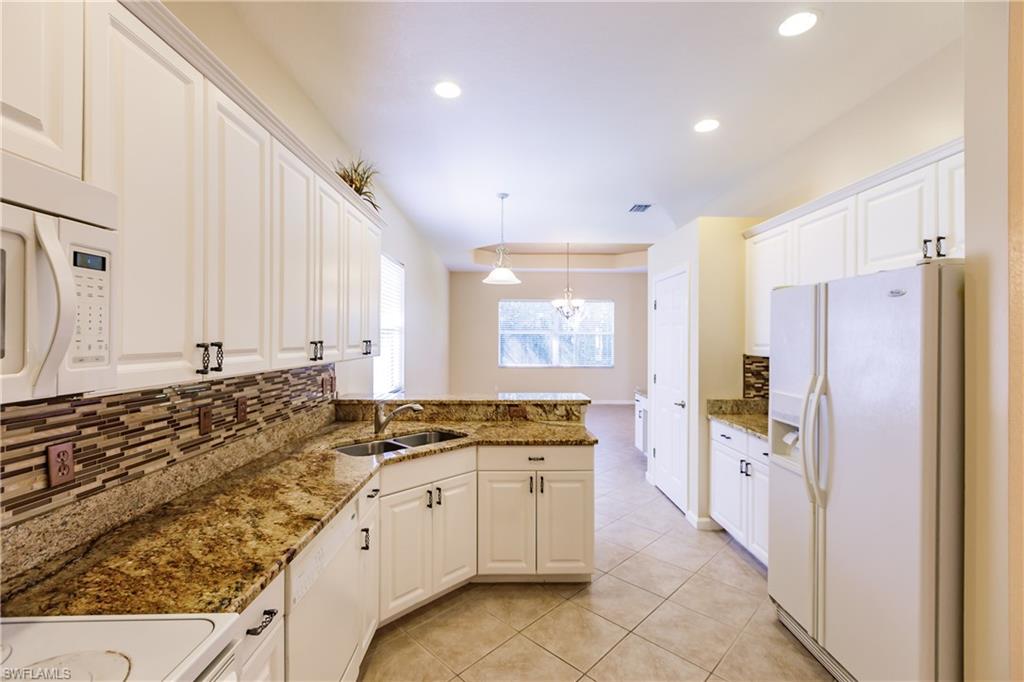 7868 Founders Circle Naples, FL 34104 - Photo 19 of 28 a kitchen with a sink stove and refrigerator