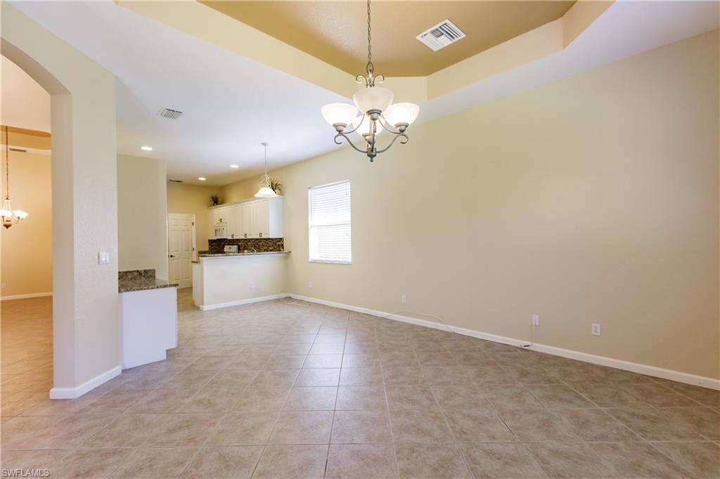 7868 Founders Circle Naples, FL 34104 - Photo 24 of 28 a view of a kitchen with a sink dishwasher a refrigerator with a chandelier