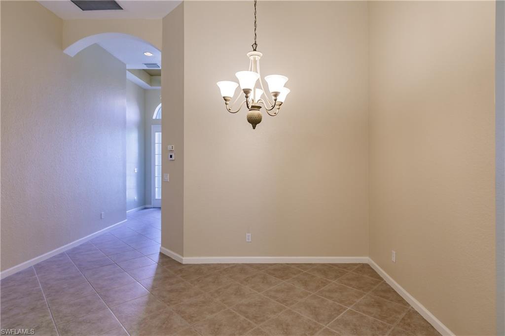 7868 Founders Circle Naples, FL 34104 - Photo 26 of 28 a view of a chandelier in big room and chandelier