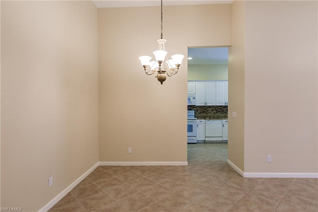 7868 Founders Circle Naples, FL 34104 - Photo 27 of 28 a view of a kitchen with a refrigerator