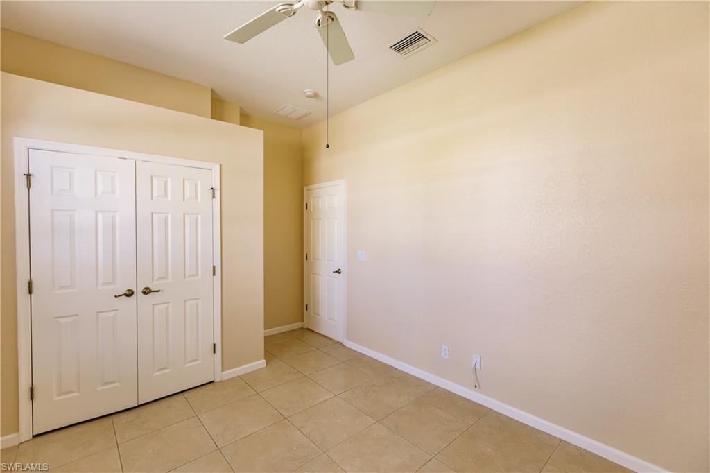 7868 Founders Circle Naples, FL 34104 - Photo 9 of 28 an empty room with a empty space and a ceiling fan