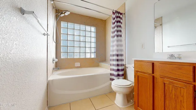 a bathroom with a granite countertop sink toilet a mirror and shower