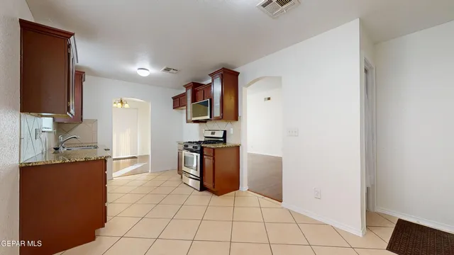 a kitchen with stainless steel appliances a refrigerator sink and stove