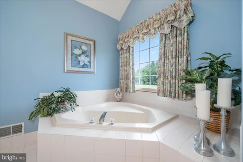 a bathroom with a bathtub and a sink