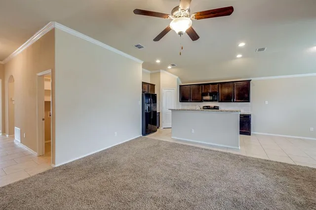a kitchen with stainless steel appliances granite countertop a refrigerator stove and sink
