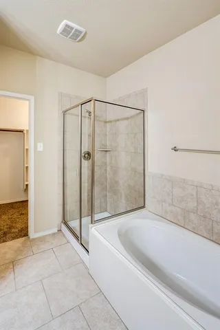 a bathroom with a tub sink vanity and mirror