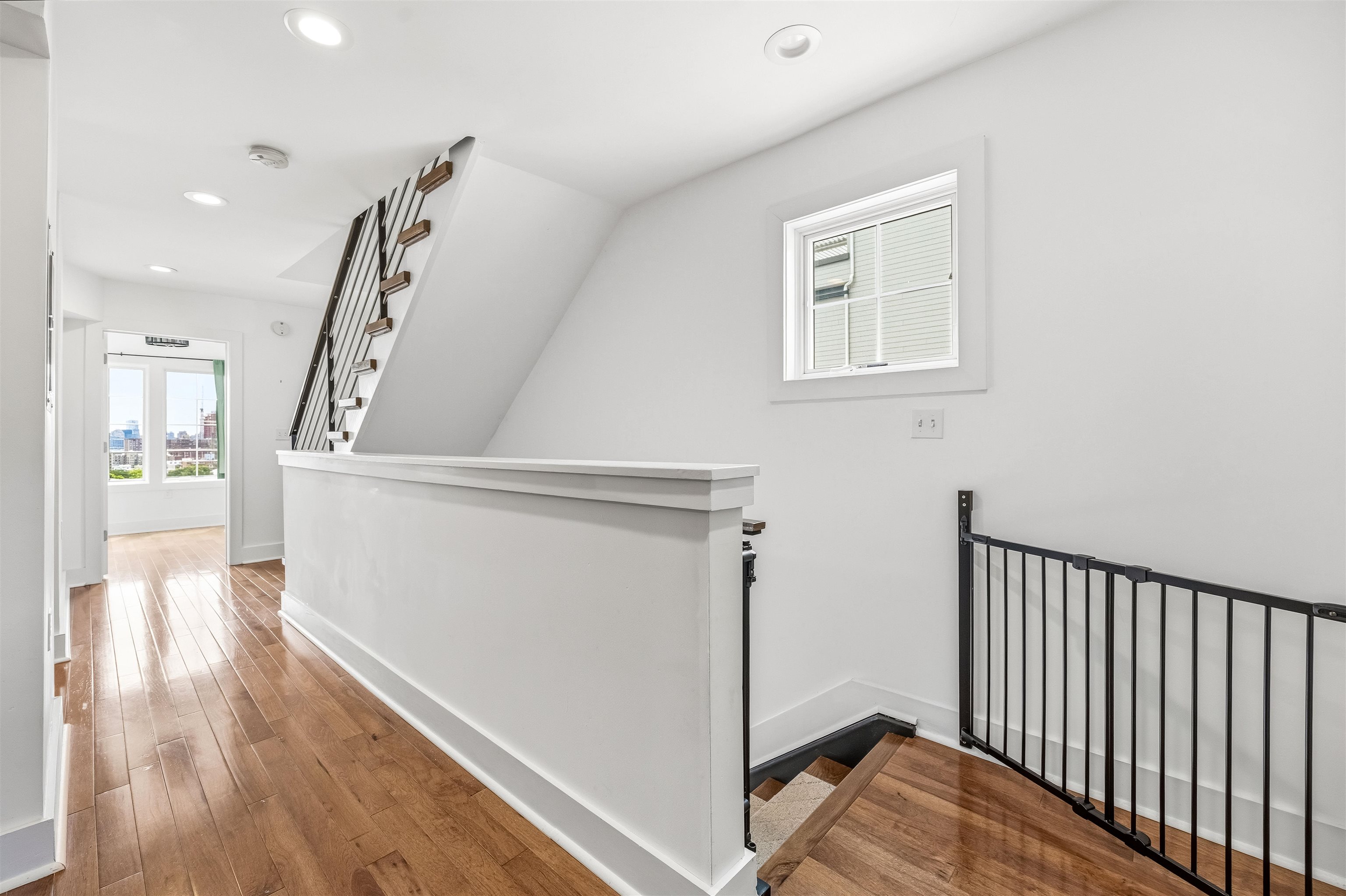 107 Mountain Road Jersey City, NJ 07307 - Photo 28 of 41 a view of a hallway with wooden floor and stairs