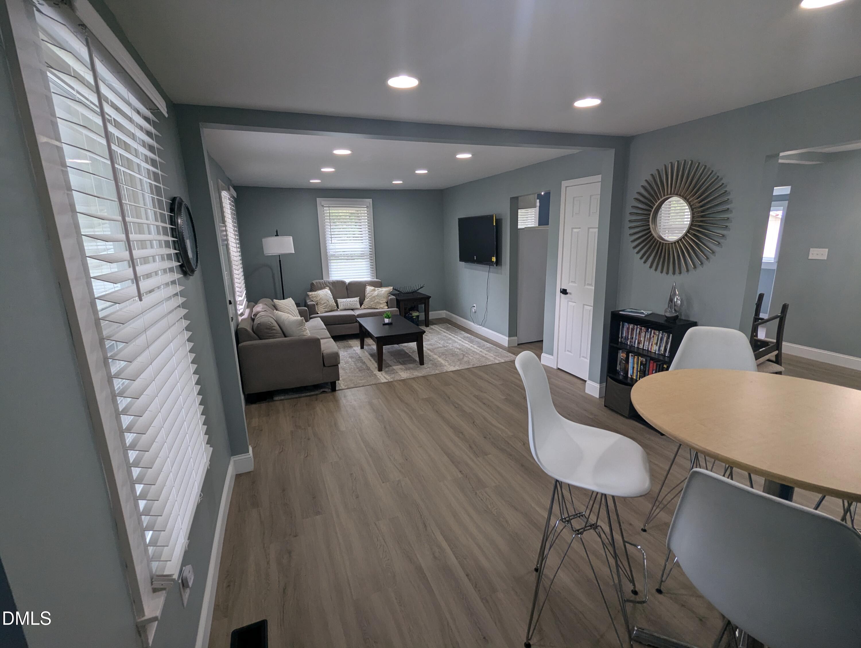 210 Grapevine Drive Roxboro, NC 27574 - Photo 12 of 31 a living room with furniture and a wooden floor