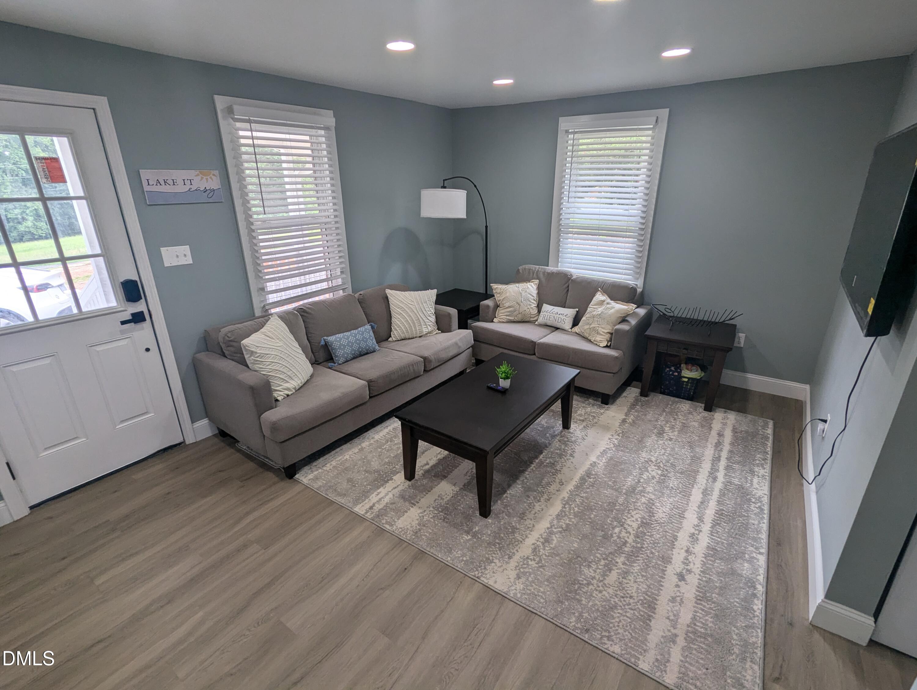 210 Grapevine Drive Roxboro, NC 27574 - Photo 13 of 31 a living room with furniture and a flat screen tv