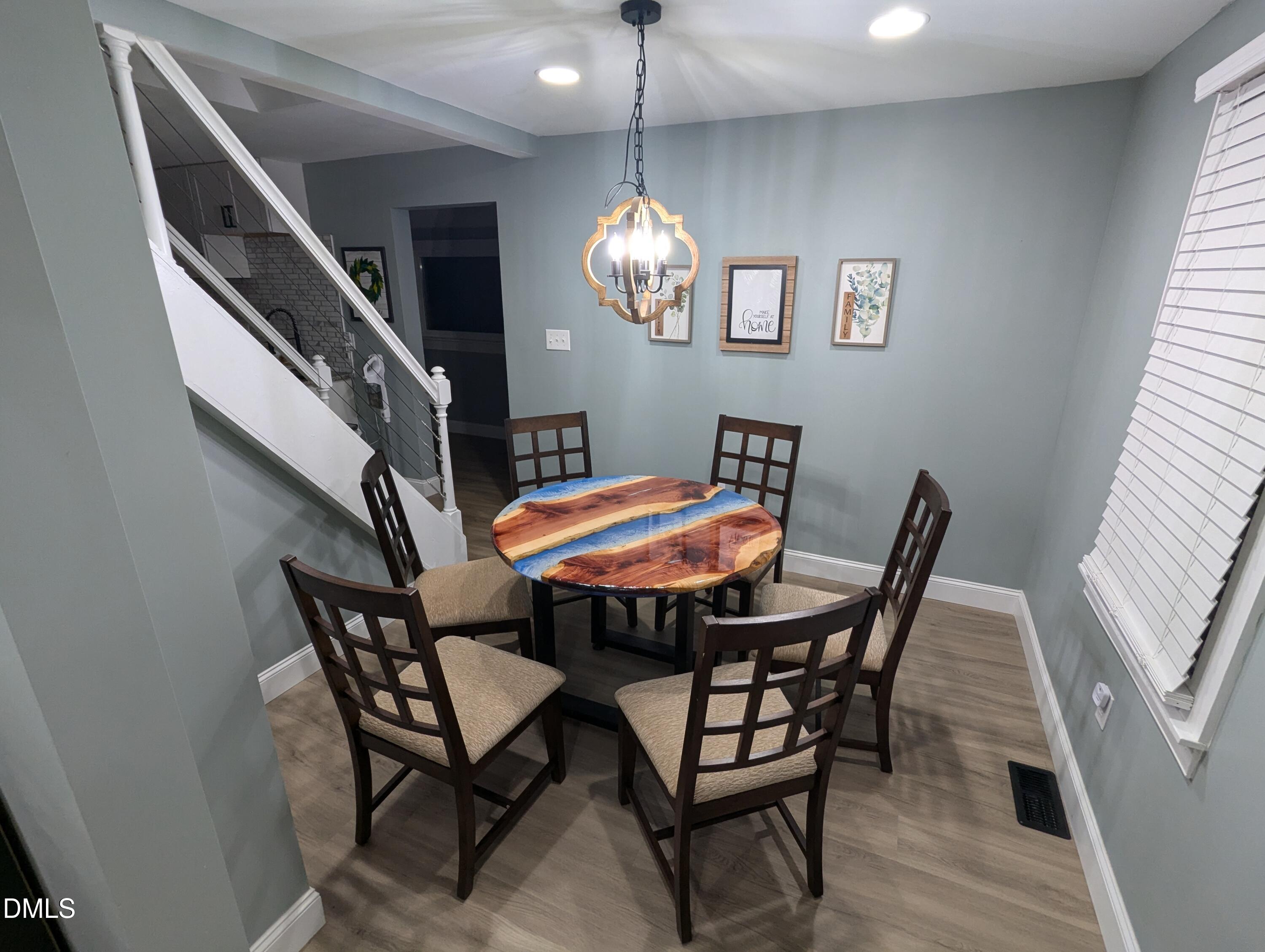 210 Grapevine Drive Roxboro, NC 27574 - Photo 20 of 31 a view of a dining room with furniture and a chandelier