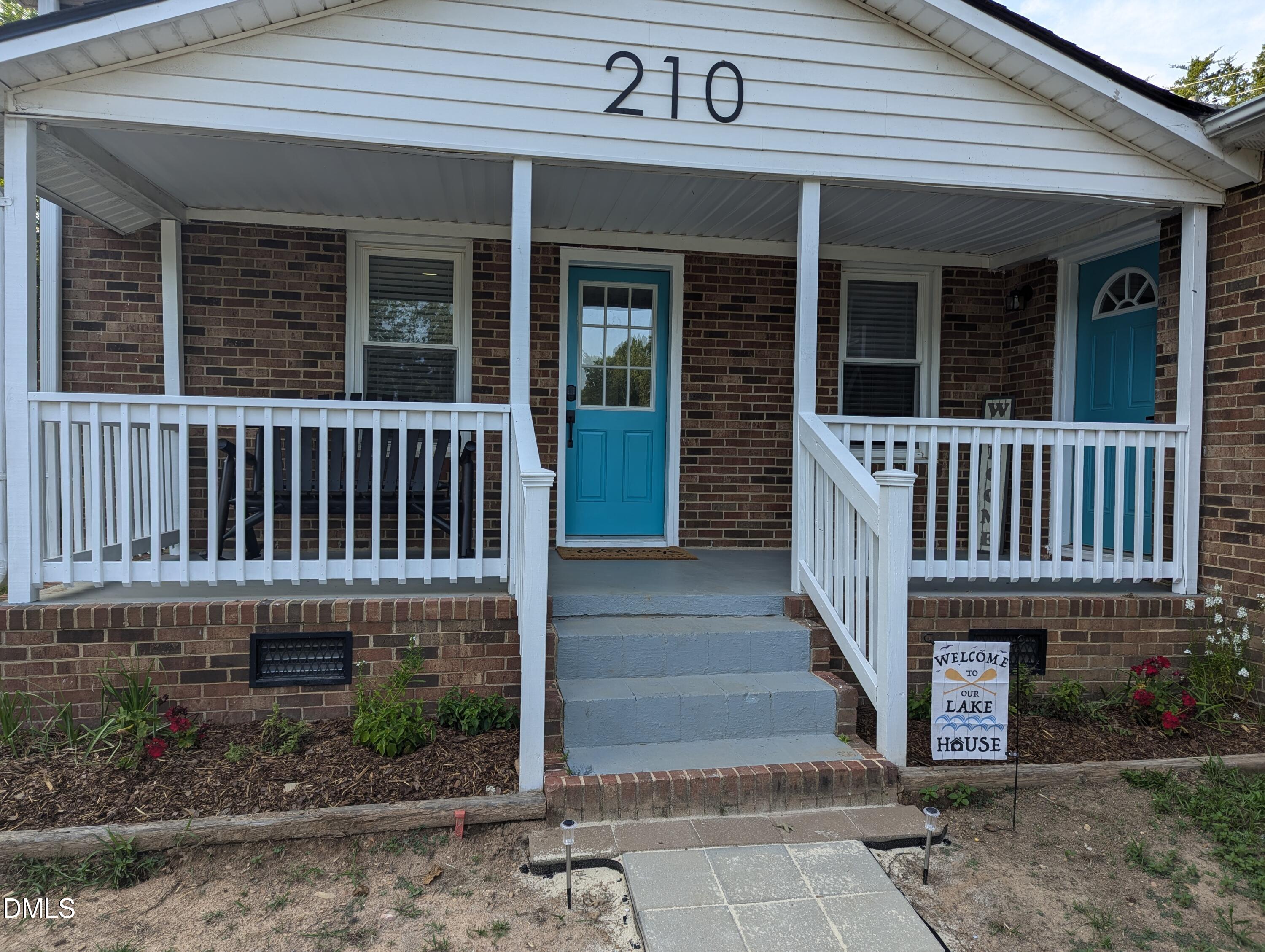 210 Grapevine Drive Roxboro, NC 27574 - Photo 3 of 31 a view of a house with wooden deck and a floor to ceiling window