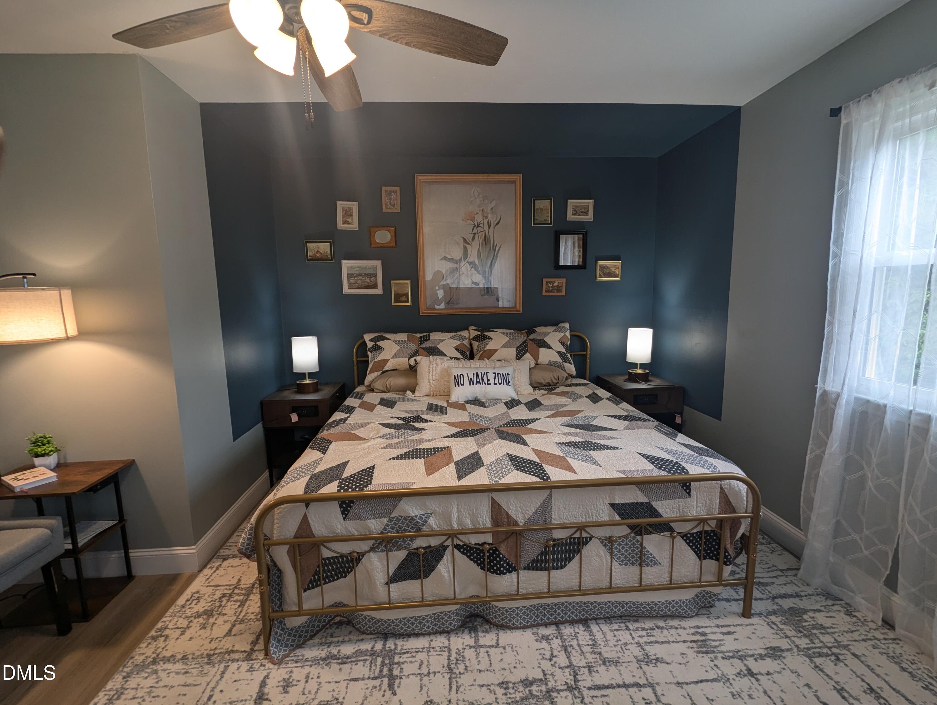 210 Grapevine Drive Roxboro, NC 27574 - Photo 6 of 31 a bedroom with a bed and wooden floor