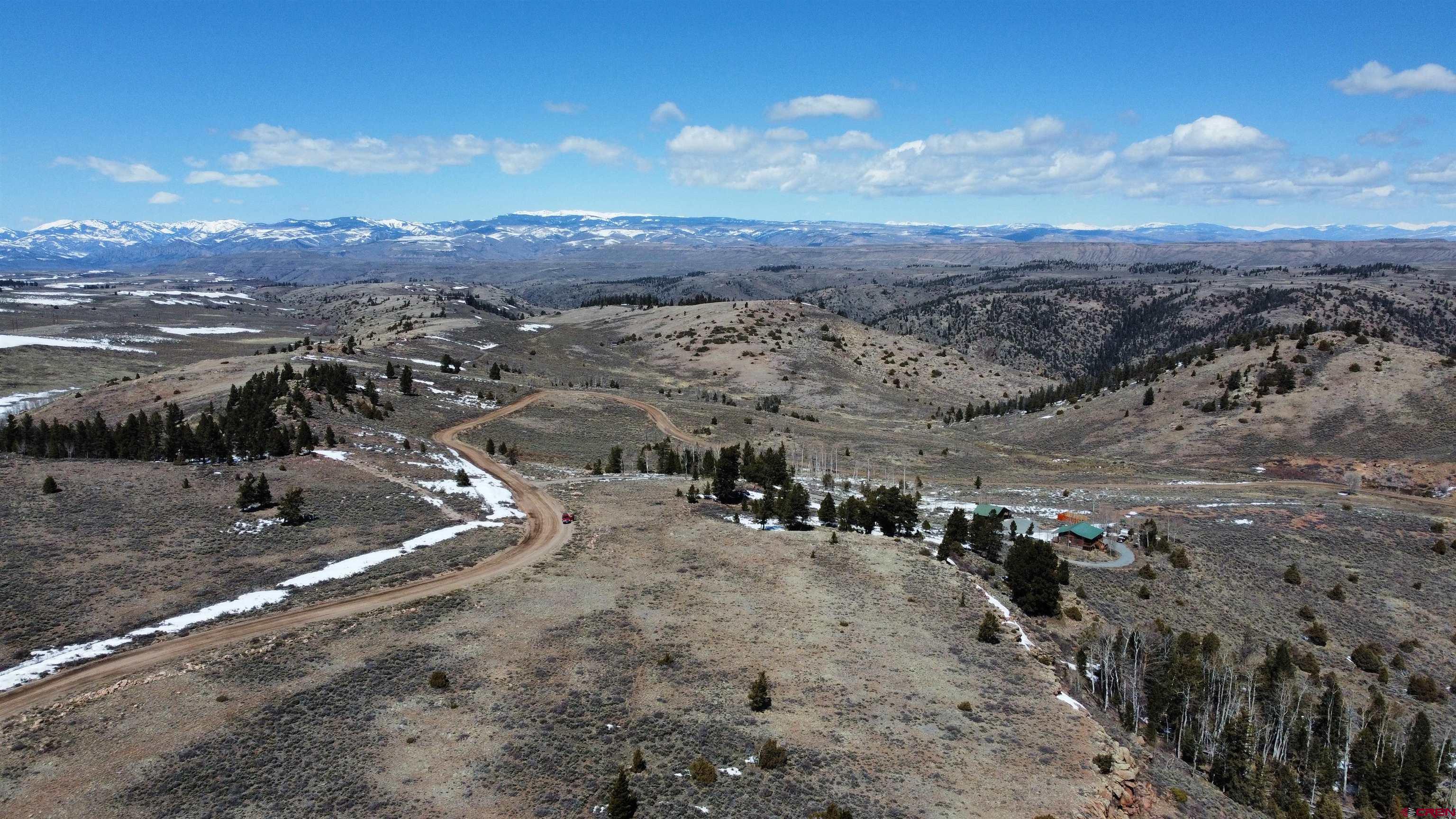 98 Blue Mesa Drive Powderhorn, CO 81243 - Photo 7 of 18 a view of a town with mountains in the background