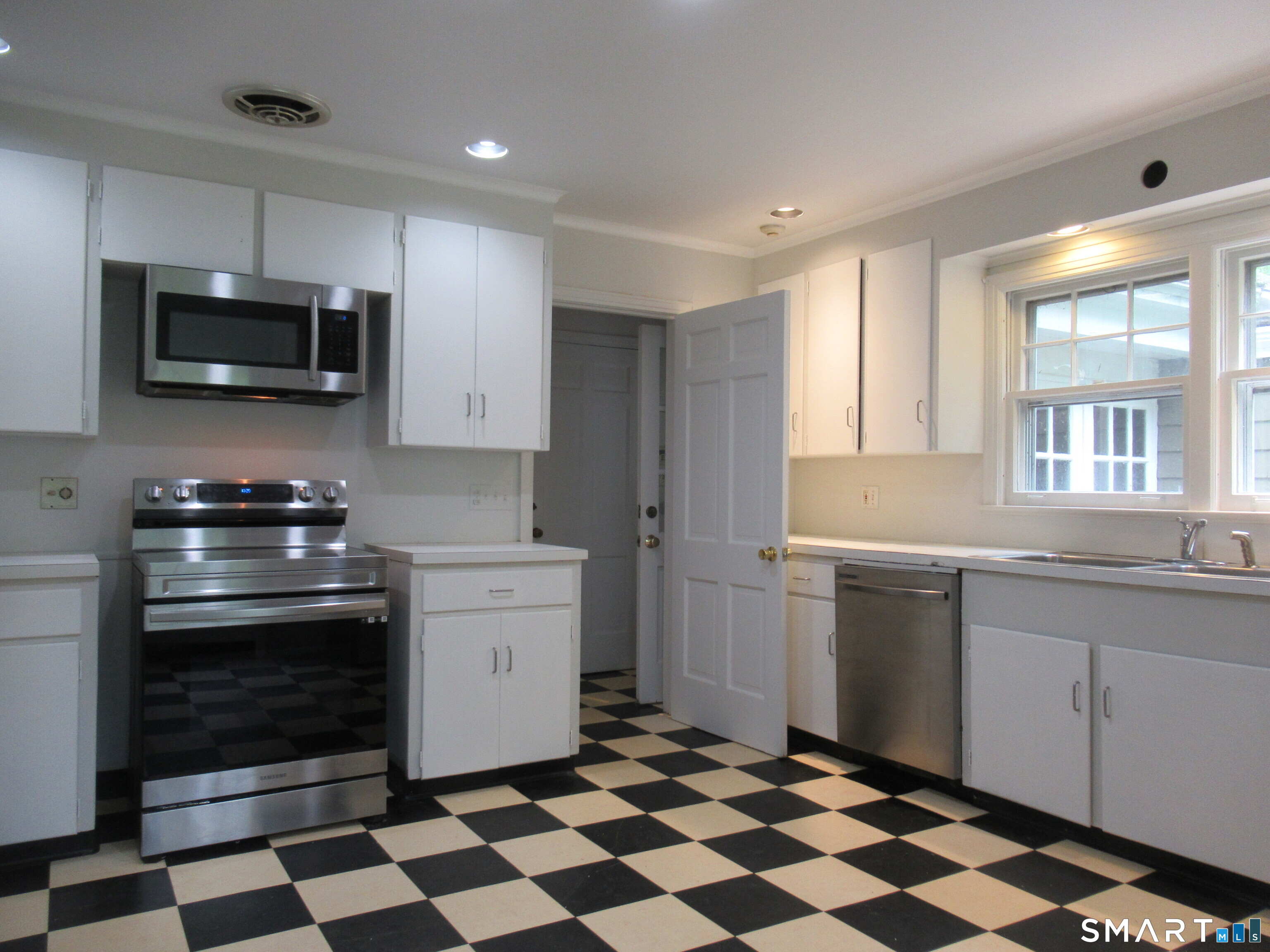 11 Burnt Swamp Road Woodbridge, CT 06525 - Photo 8 of 29 a kitchen with a stove a sink and a microwave