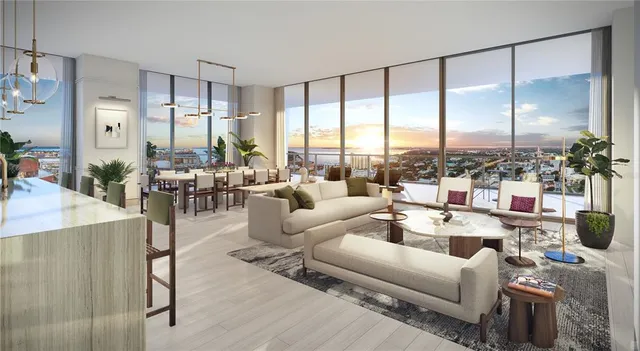a living room with furniture kitchen view and a chandelier