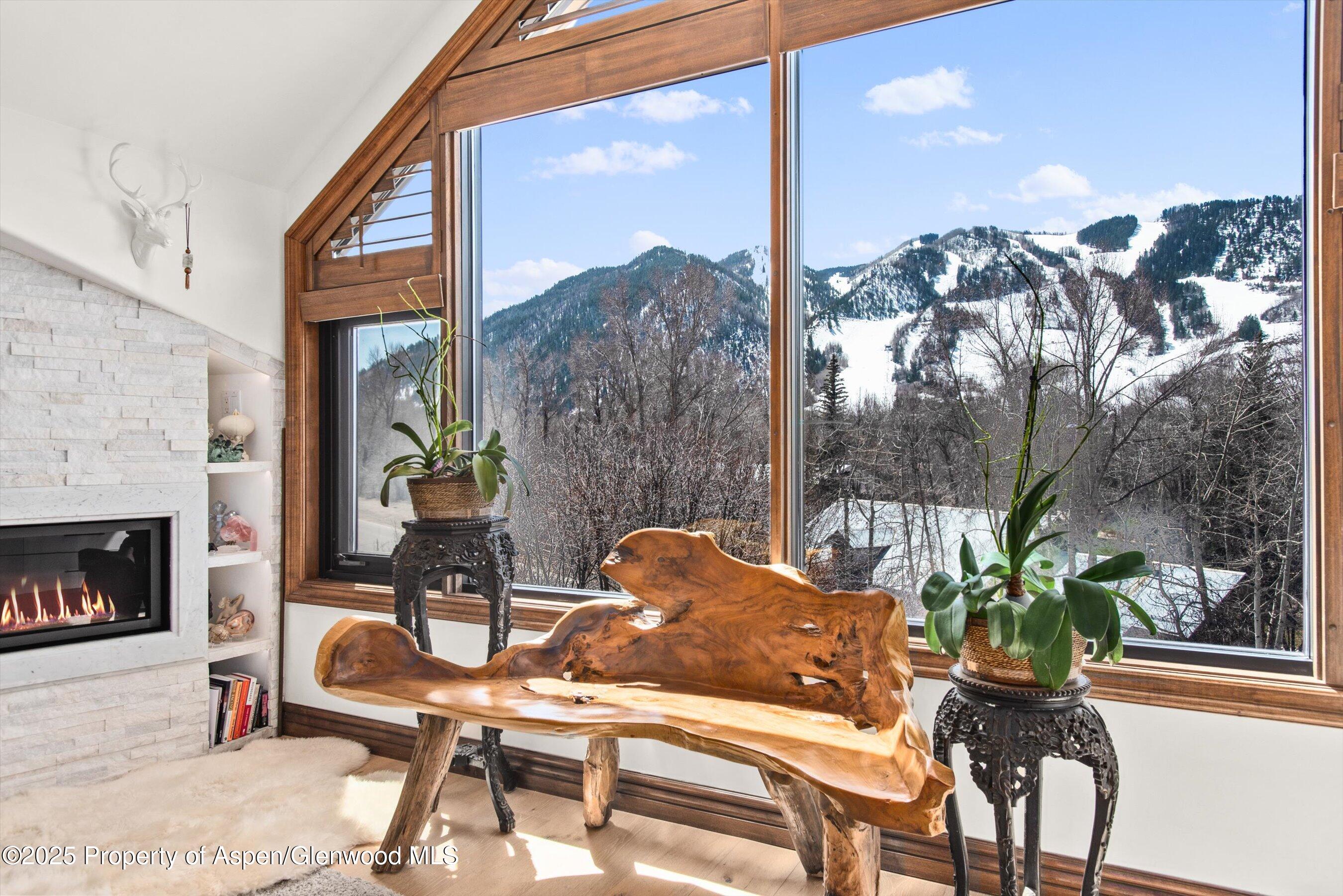 155 Lone Pine Road, Unit 9 Aspen, CO 81611 - Photo 12 of 27 a dining room with furniture and a fireplace