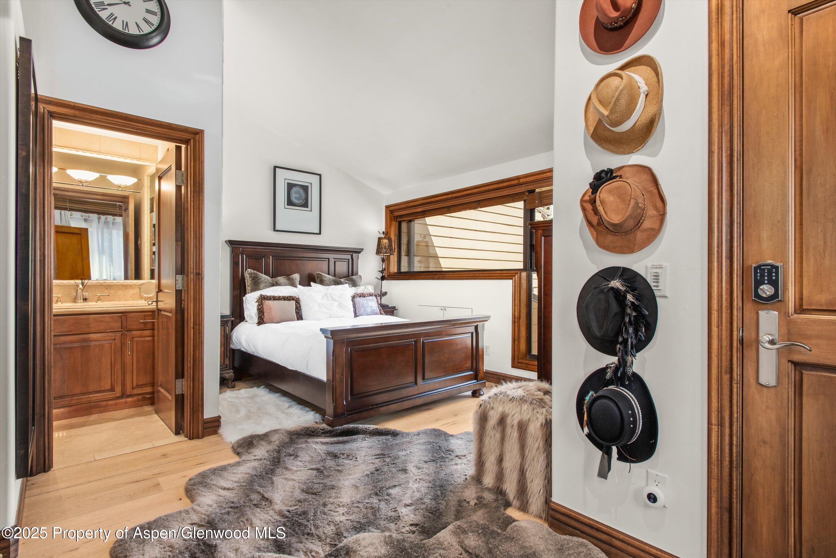 155 Lone Pine Road, Unit 9 Aspen, CO 81611 - Photo 16 of 27 a bedroom with a bed and cabinets