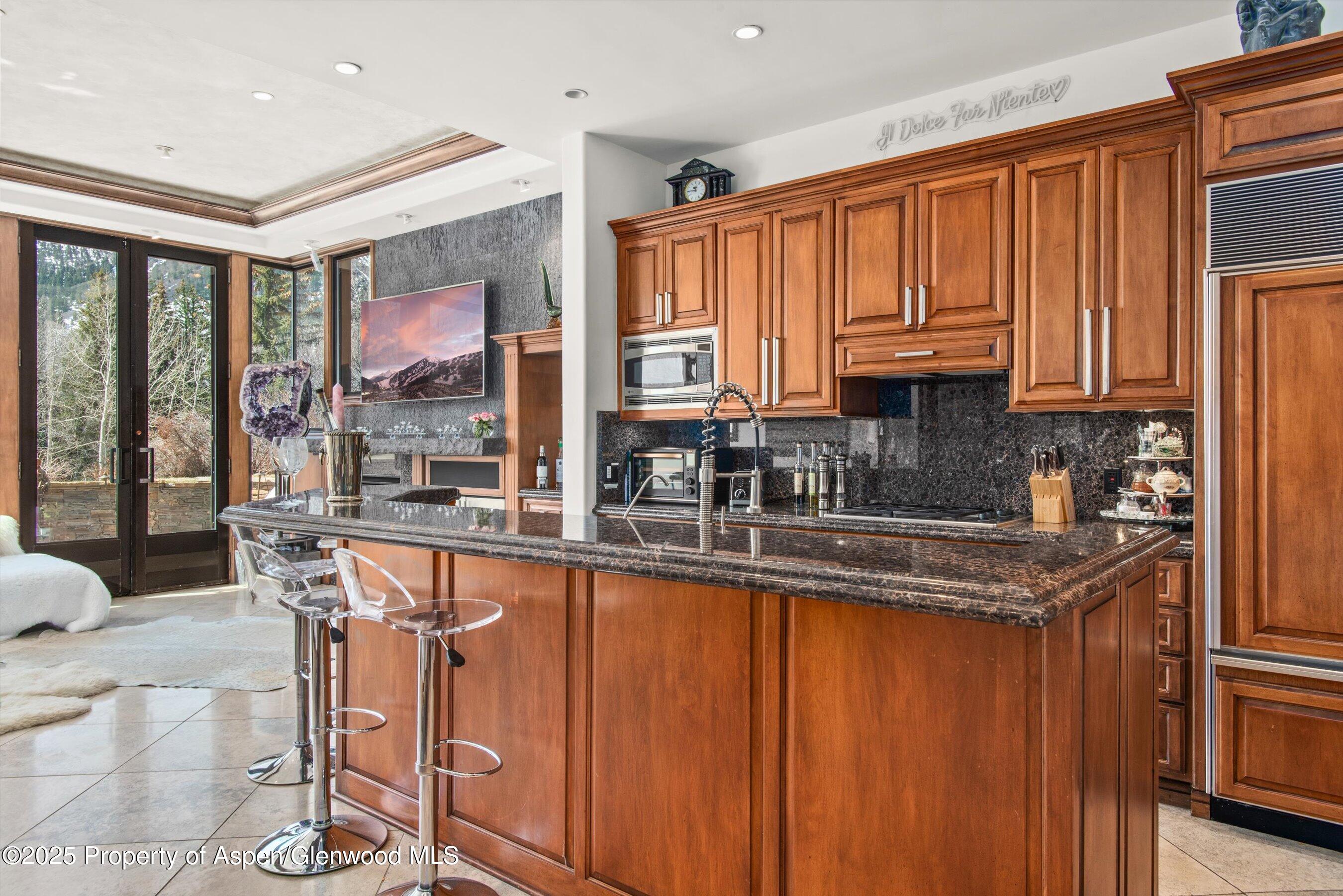 155 Lone Pine Road, Unit 9 Aspen, CO 81611 - Photo 3 of 27 a kitchen with stainless steel appliances granite countertop a stove a sink dishwasher and cabinets with wooden floor