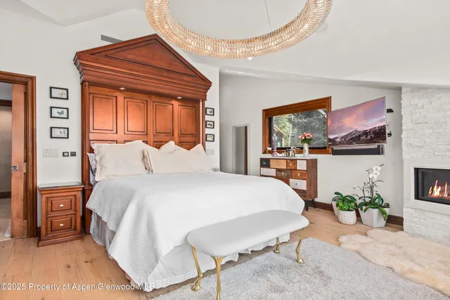 a bathroom with a granite countertop sink a toilet and a large mirror