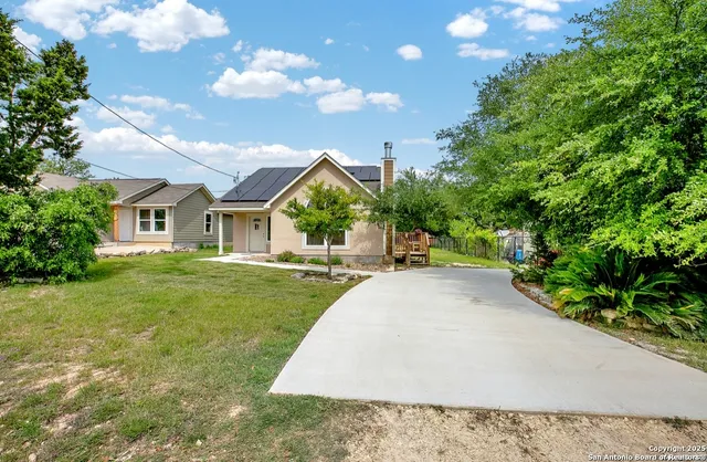 a view of an house with backyard space and garden