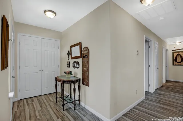 a view of a hallway with wooden floor and workspace