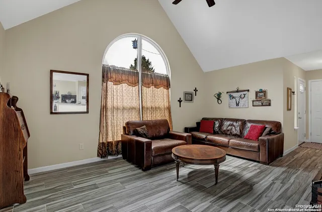 a living room with furniture and a large window