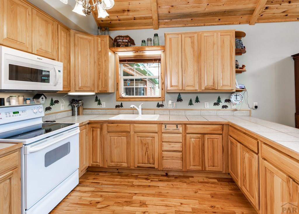 331 Westcliffe Drive Rye, CO 81069 - Photo 29 of 48 a kitchen with stainless steel appliances sink cabinets and window
