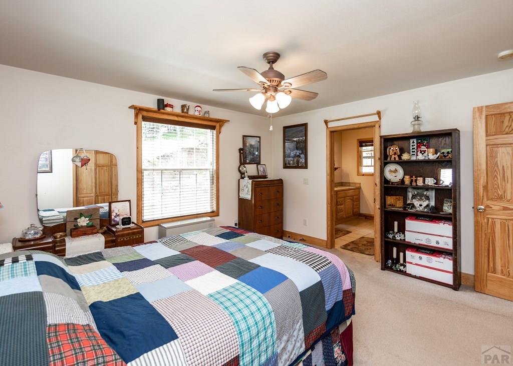 331 Westcliffe Drive Rye, CO 81069 - Photo 37 of 48 a bedroom with a bed a dresser and a large window
