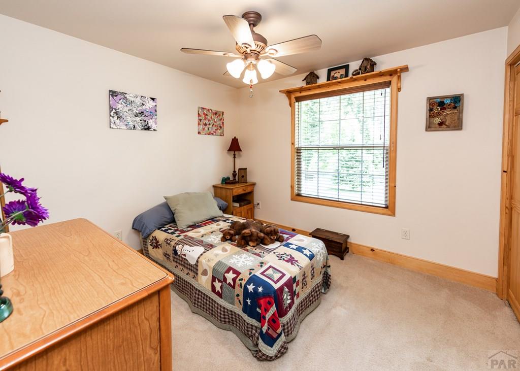 331 Westcliffe Drive Rye, CO 81069 - Photo 39 of 48 a bedroom with a bed a window and a dresser