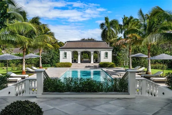 an aerial view of a house with a yard swimming pool and outdoor seating