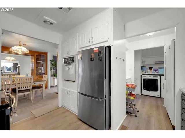 a kitchen with stainless steel appliances a refrigerator and a stove top oven