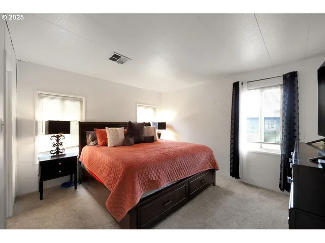 a bedroom with a bed and a night stand