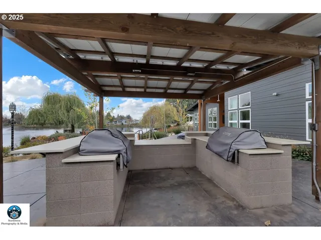 a living room with lots of furniture and a view of kitchen