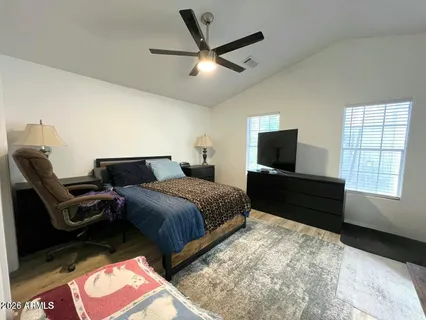 a bedroom with a bed and a flat screen tv