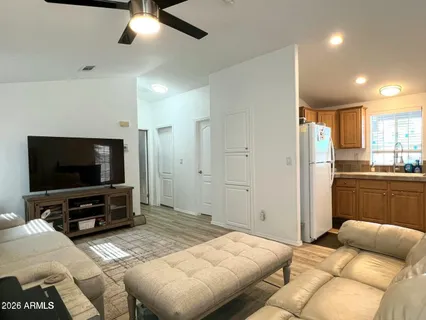 a bedroom with furniture and a flat screen tv