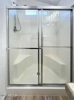 a bathroom with a glass shower door