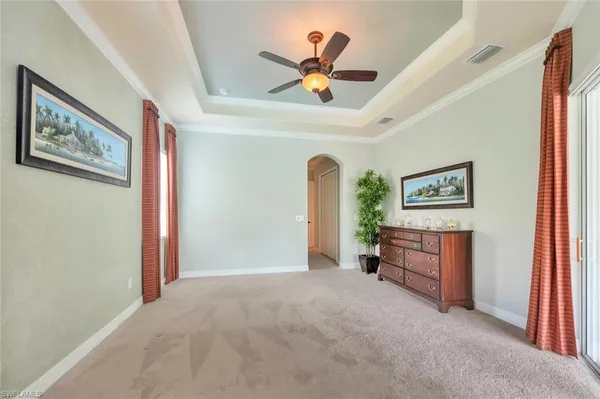 a view of a livingroom with a ceiling fan and a bookshelf