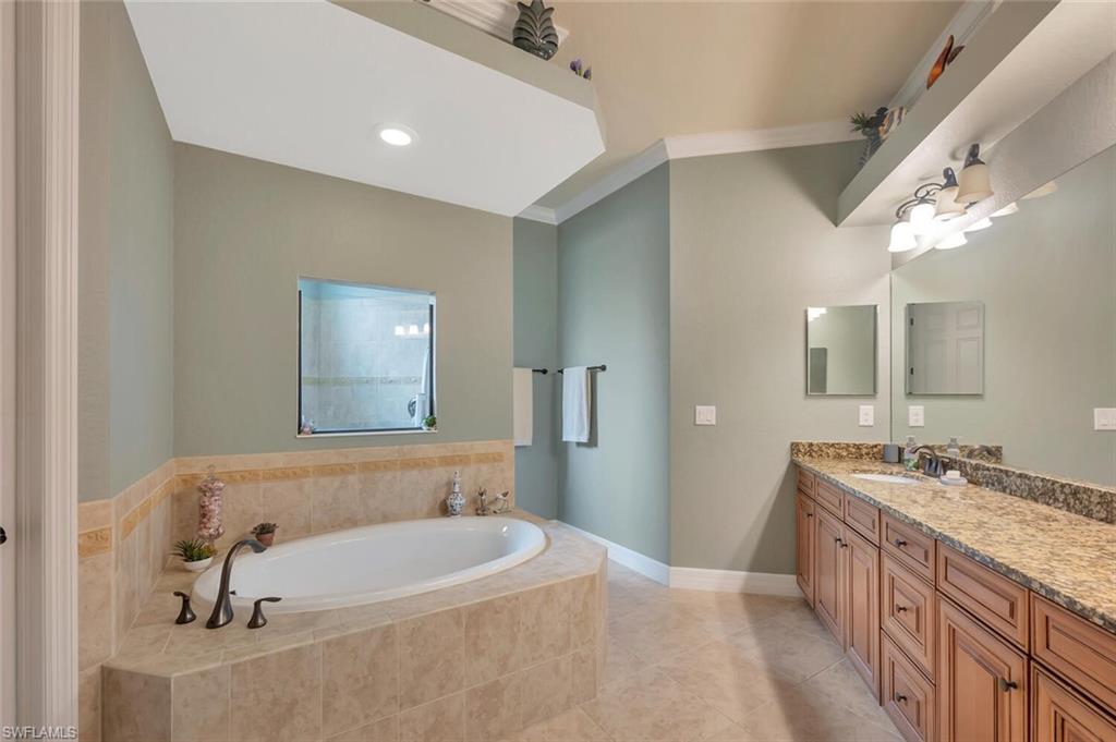 21093 Torre Del Lago Street Estero, FL 33928 - Photo 17 of 37 a spacious bathroom with a tub sink and mirror