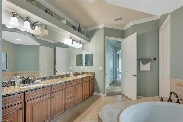 a spacious bathroom with a double vanity sink mirror and double