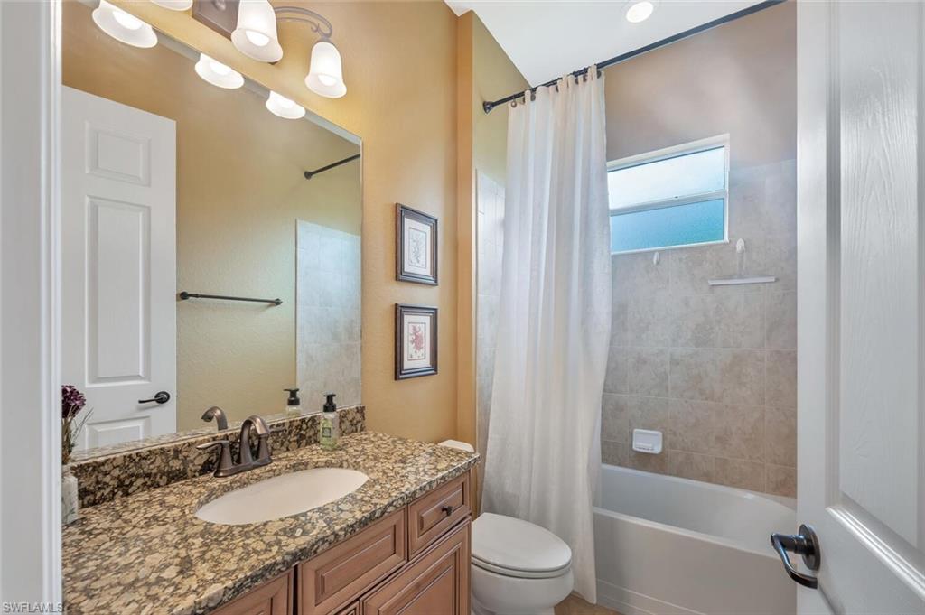 21093 Torre Del Lago Street Estero, FL 33928 - Photo 21 of 37 a bathroom with a granite countertop sink a toilet and shower