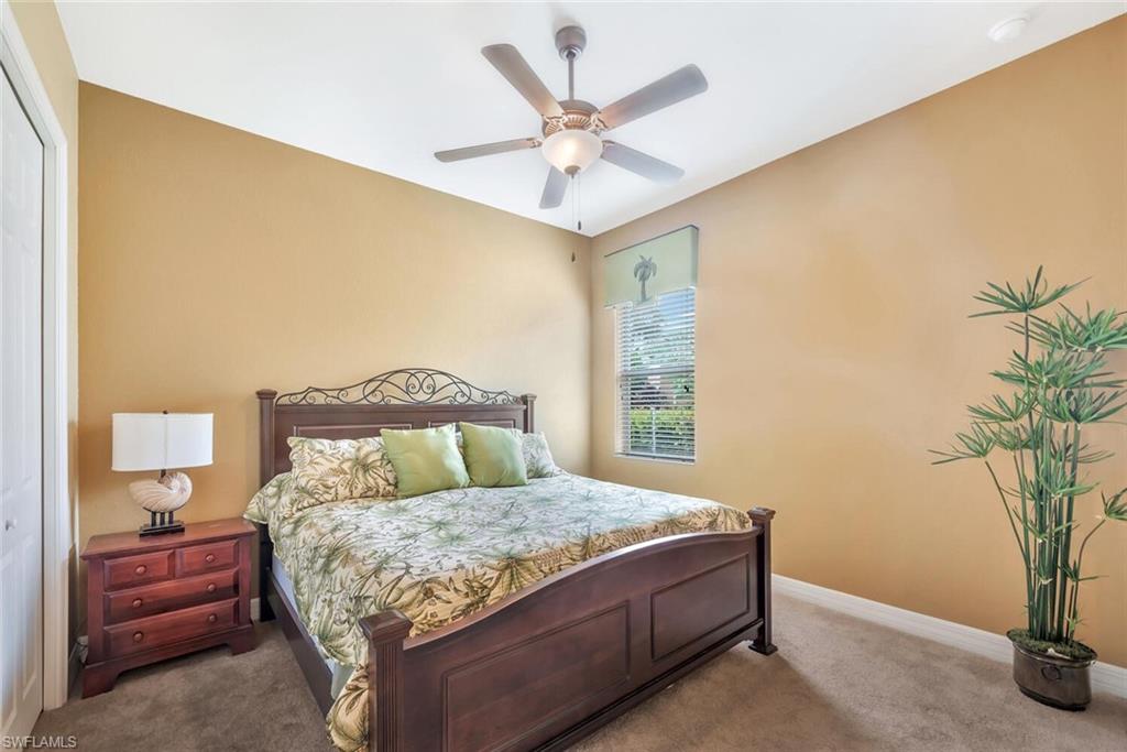 21093 Torre Del Lago Street Estero, FL 33928 - Photo 22 of 37 a bedroom with a bed and a potted plant