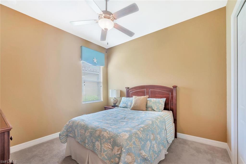 21093 Torre Del Lago Street Estero, FL 33928 - Photo 23 of 37 a bedroom with a bed and a chandelier