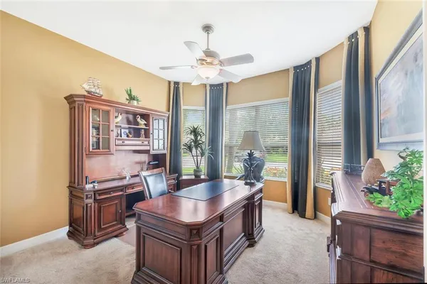 a kitchen with kitchen island a stove a counter top space and living room view