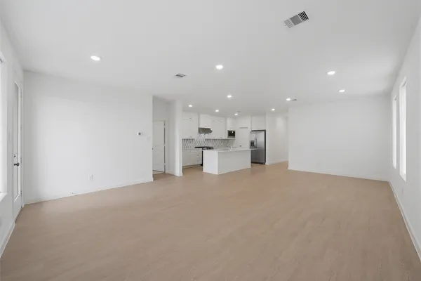 a view of a kitchen with white cabinets