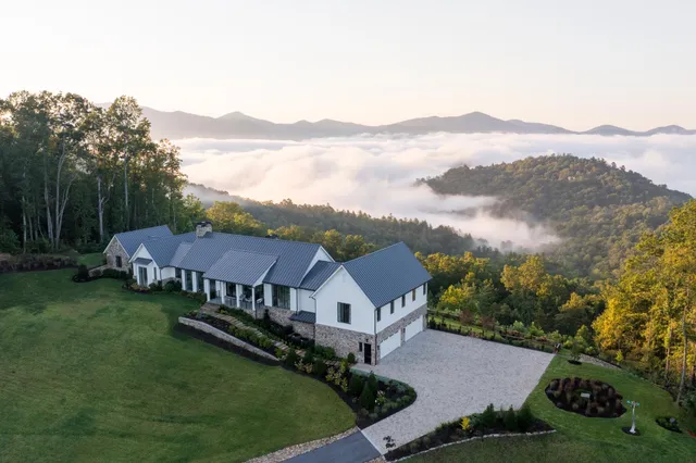 a bedroom with furniture and a large window